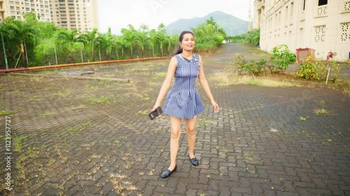 Joyful Woman Dancing Outdoors with Smartphone