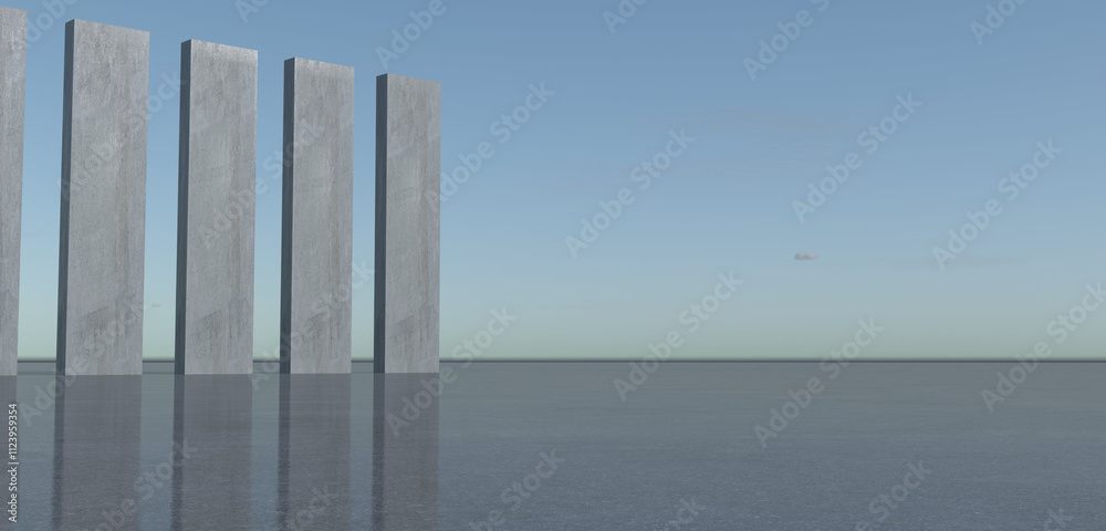 Rectangular pillars standing on a dark gray, smooth surface. The pillars are evenly spaced. The background features a sunset sky with soft Rectangular pillars standing on a dark gray, smooth surface. The pillars are evenly spaced. The background features a sunset sky with soft