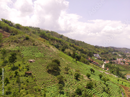 Majestic Ridge in the Cicalengka highlands, Indonesia. Gentle slopes with panoramic rice fields and villages along the valley. Countryside View. Drone Aerial. Landscape Photography photo