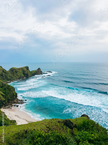 Fotografie A breathtaking seascape with vibrant green cliffs descending into the blue sea,