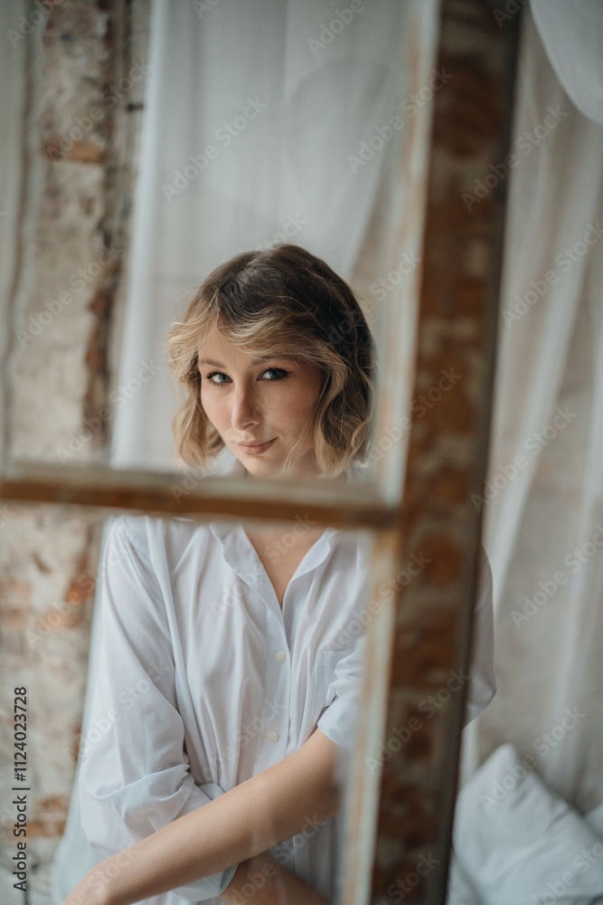 sexy woman in white shirt through the window frame.