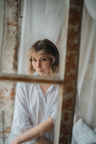 Obraz na płótnie sexy woman in white shirt through the window frame. w salonie