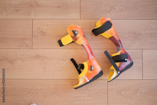 Colorful Child Orthopedic Braces on Wooden Floor photo