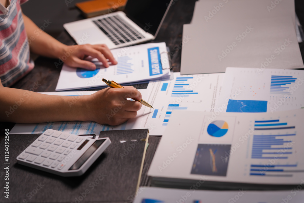 A man working late at home sits at his desk analyzing financial charts, checking stock market data on a laptop, tablet, and mobile, surrounded by informal, technology-driven tools. A man working late at home sits at his desk analyzing financial charts, checking stock market data on a laptop, tablet, and mobile, surrounded by informal, technology-driven tools.