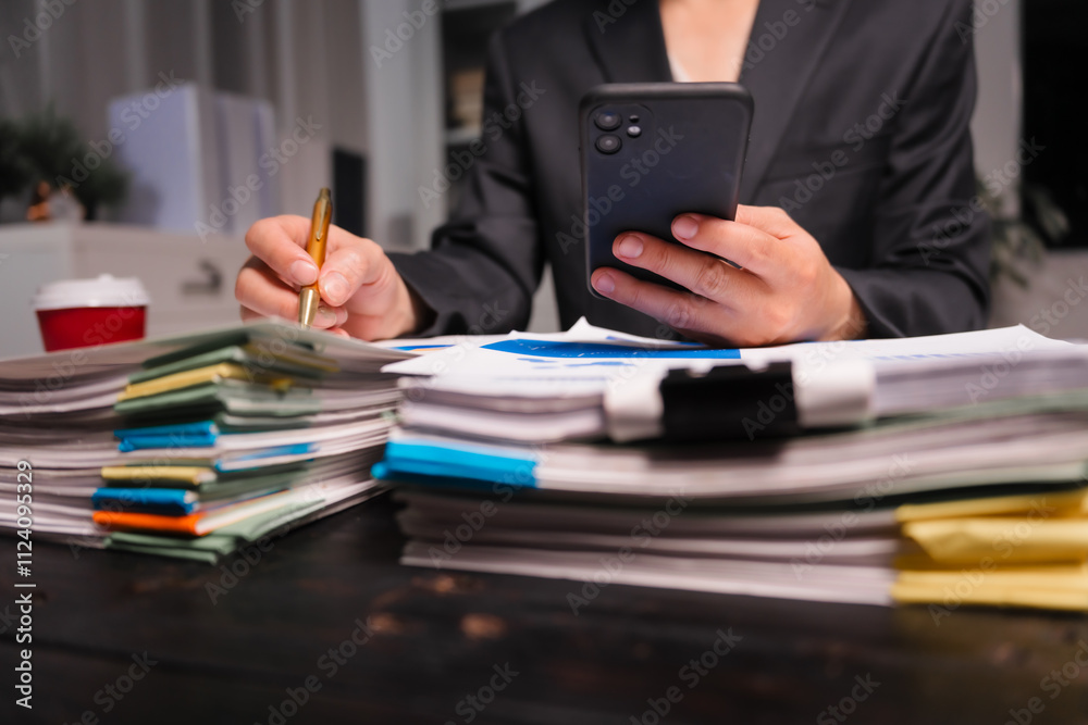 A young Asian man in a formal suit works late at night at his desk, analyzing stock market charts on a laptop and tablet, ensuring accuracy in financial data analysis. A young Asian man in a formal suit works late at night at his desk, analyzing stock market charts on a laptop and tablet, ensuring accuracy in financial data analysis.