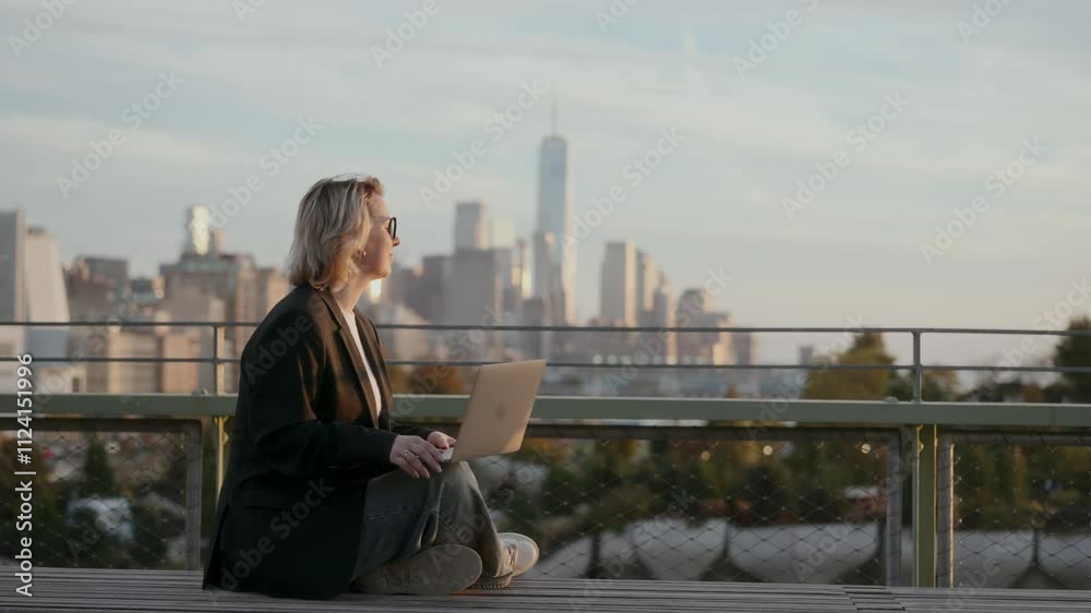 Professional confidently works on laptop against stunning city skyline backdrop Professional confidently works on laptop against stunning city skyline backdrop