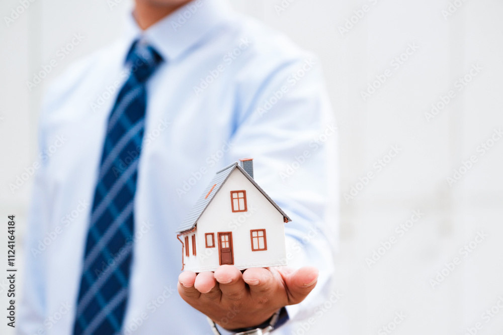 Real Estate Agent Protecting House Model in Hand Real Estate Agent Protecting House Model in Hand
