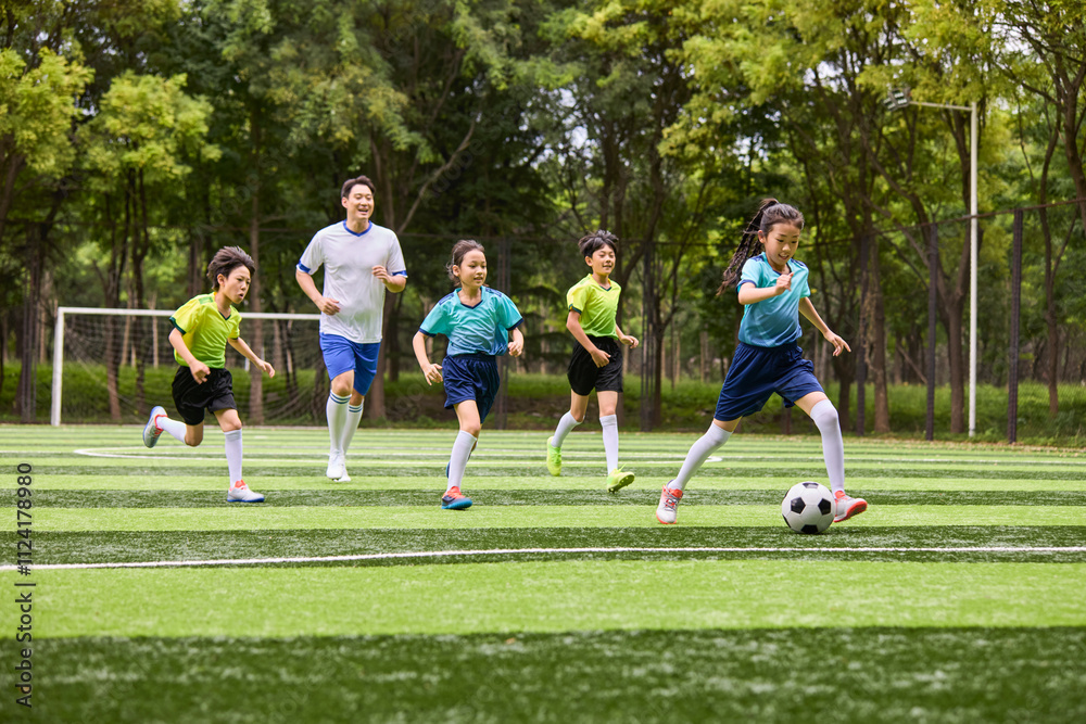 Chinese Kids Playing Football on Soccer Field Chinese Kids Playing Football on Soccer Field