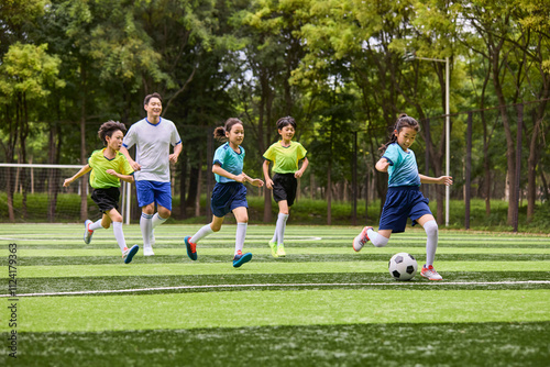 Chinese Kids Playing Football on Soccer Field