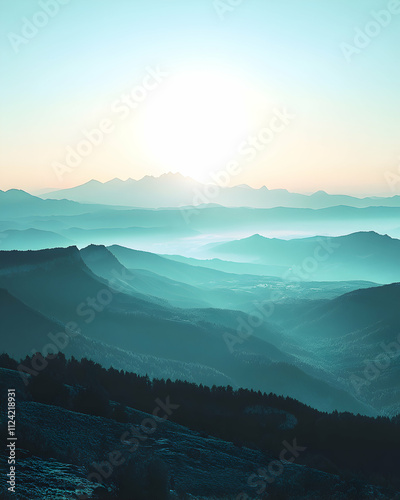 Serene sunrise over layered teal mountains, misty valleys, peaceful landscape. Perfect for travel, nature, and meditation themes. photo