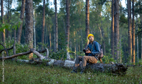 Photographer is taking photo of the new discovering bird species while exploring in the pine forest for surveying and locating rare biological diversity and ecologist on field study