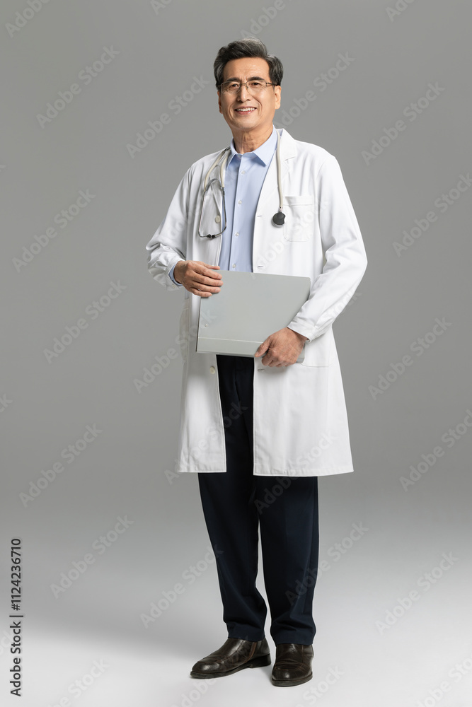 Senior male doctor with laptop