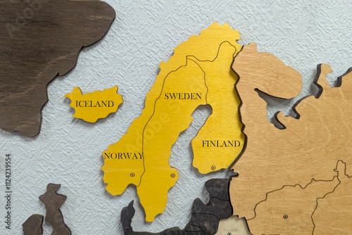 North Europa on the political map. Wooden world map on the wall. Scandinavia, Finland, Sweden, Norway, Iceland photo