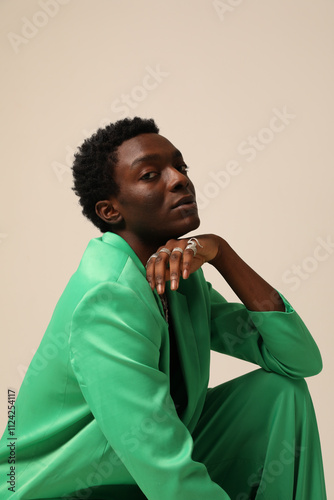 Headshot of young African American man looking at the camera and posing over light background. Vertical mock-up.