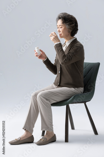 Senior Chinese woman taking pills