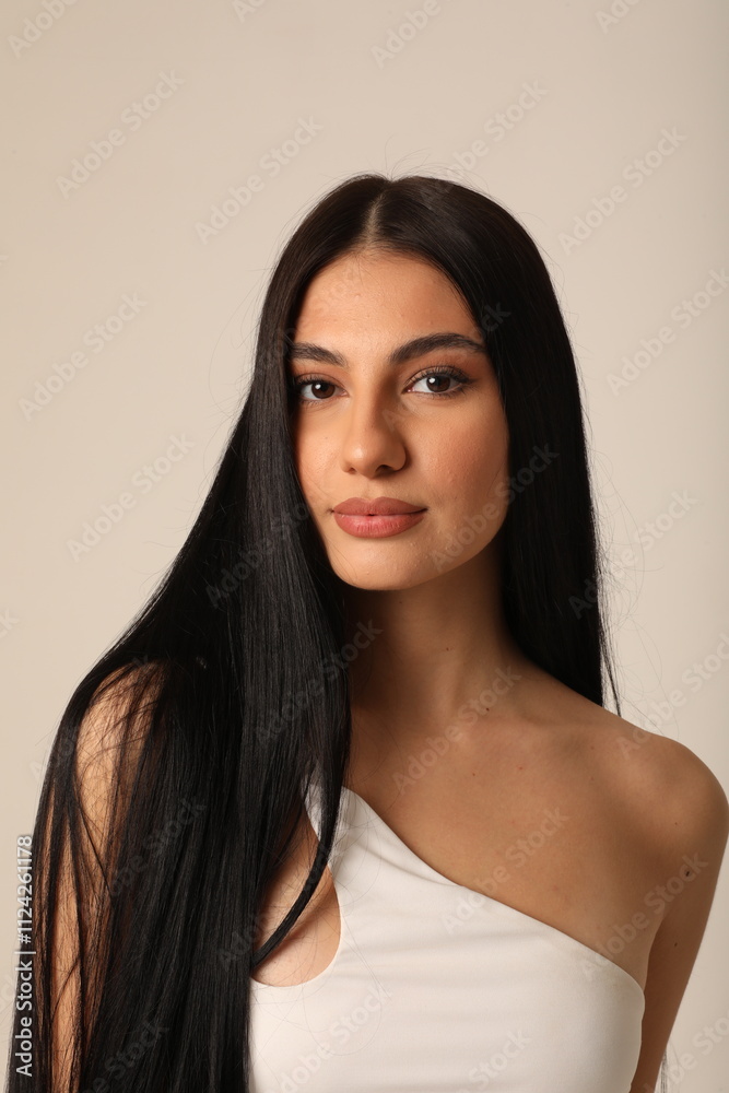Φωτογραφία Close-up of beautiful young woman with long dark hair looking at the camera