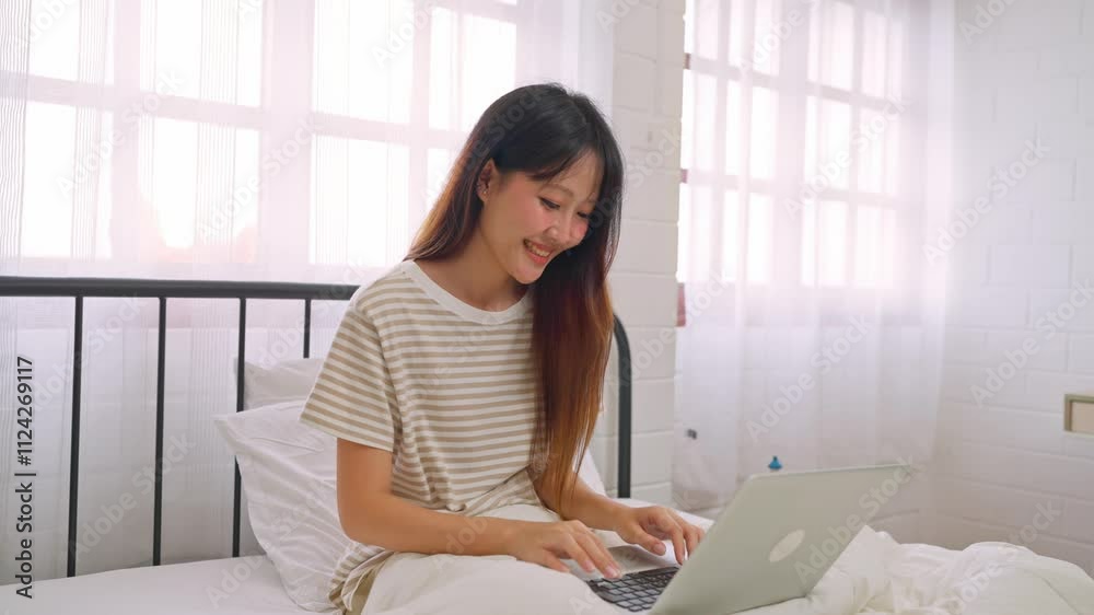 Asian beautiful woman student using laptop device in bedroom at home. Asian beautiful woman student using laptop device in bedroom at home.