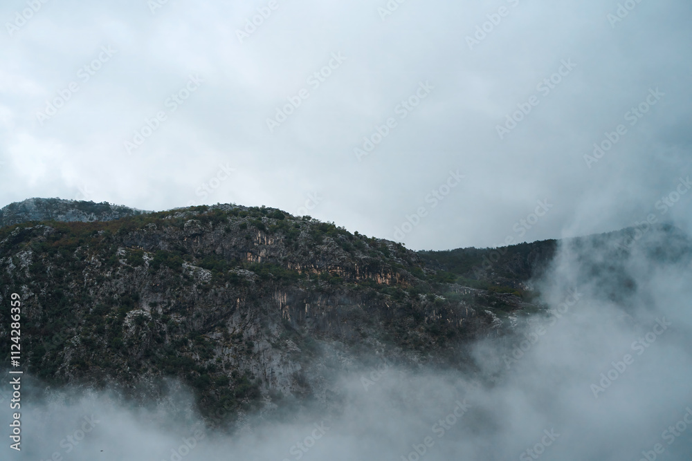 Misty valley view with forested hills and water Misty valley view with forested hills and water