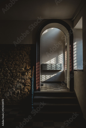 An arched doorway with slanting sunlight