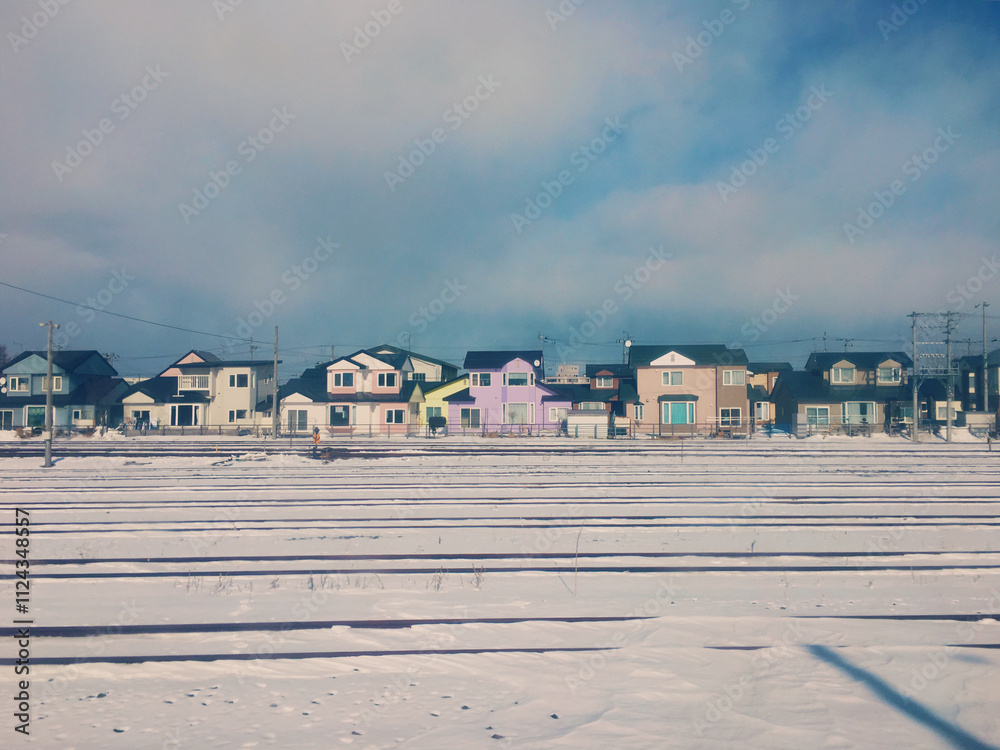 colorful little house in winter, and railway covered with snow colorful little house in winter, and railway covered with snow
