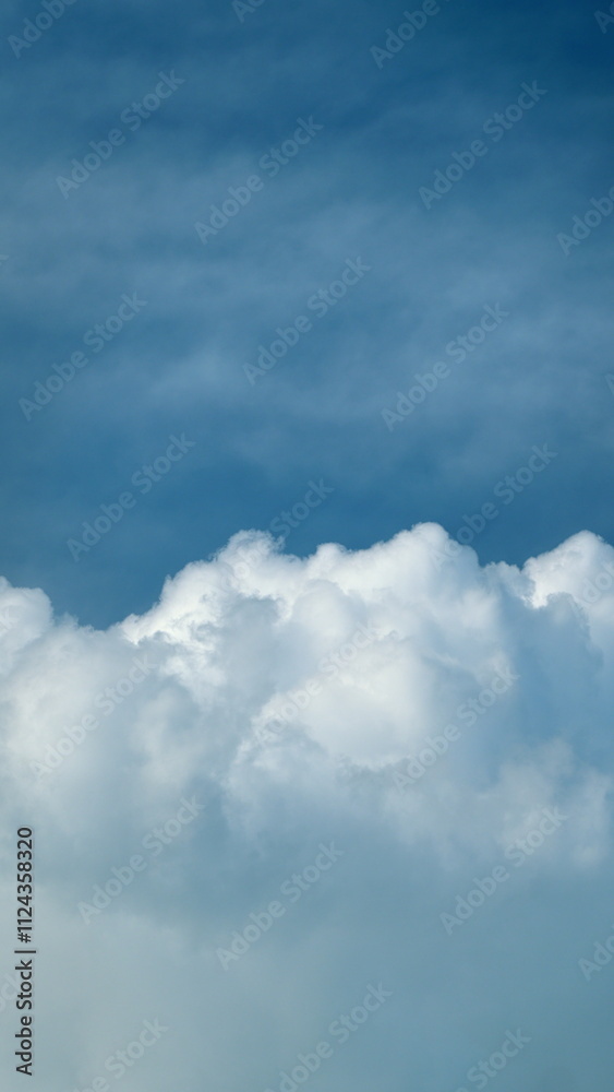 Obraz premium Summer Or Spring Sky With Cloudscape Scattered Across Horizon. Clear Blue Sky And White Clouds Summer Background. Vertical Time Lapse.