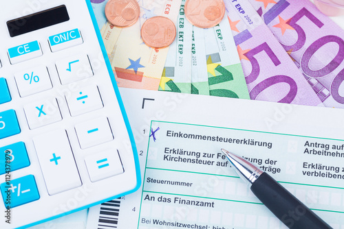 german tax form with calculator and money photo