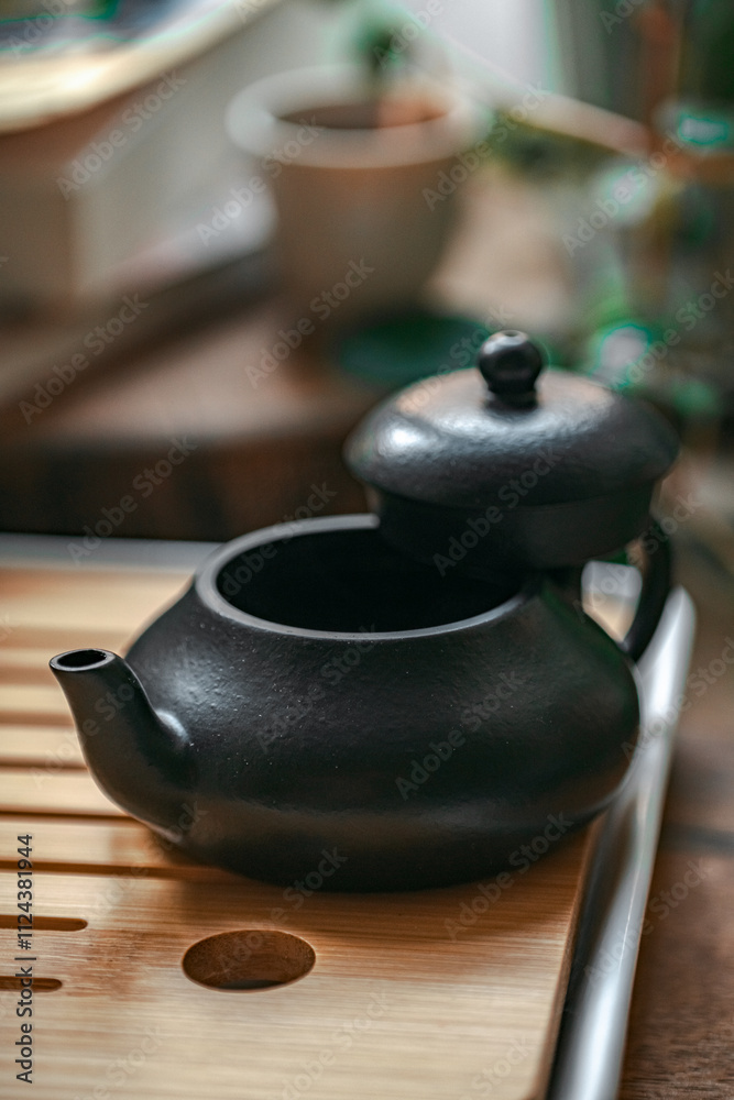 A Beautifully Designed Elegant Black Teapot on a Wooden Tray for Serene Tea Rituals A Beautifully Designed Elegant Black Teapot on a Wooden Tray for Serene Tea Rituals
