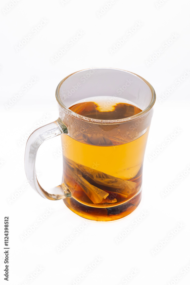 This image showcases a glass mug filled with a soothing herbal tea, its warm amber hue hinting at the natural flavors within.