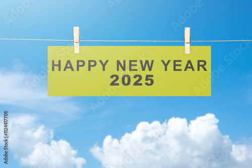 Schilderij op canvas Text of Happy New Year 2025 written on hanging paper with blue sky background