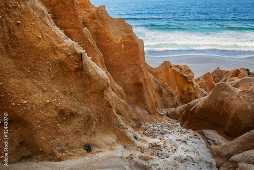 beautiful beach in the Atlantic Ocean bordered by hard sand cliffs forming a canyon Medides beach in Portugal photo