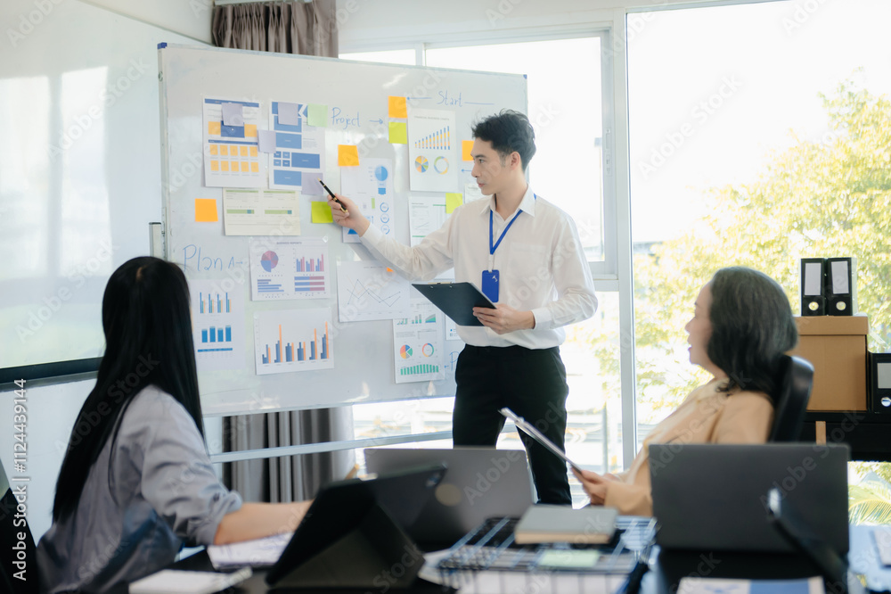 The boss stands near the board with graphs, demonstrates statistics, various personnel attending the training, The boss stands near the board with graphs, demonstrates statistics, various personnel attending the training,
