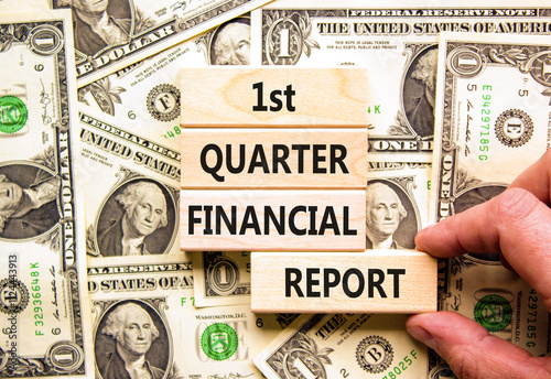 1st quarter financial report symbol. Concept words 1st quarter financial report on beautiful wooden blocks. Beautiful dollar background. Business 1st quarter financial report concept. Copy space. photo