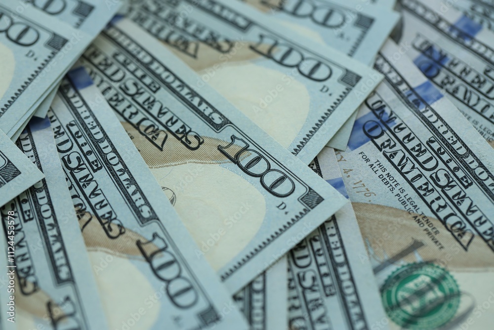 Many hundred dollar bills new banknotes in big pile under the natural light Many hundred dollar bills new banknotes in big pile under the natural light