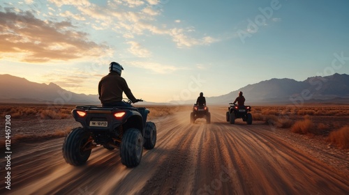 Three Adventurers Riding ATVs Through Dusty Desert Landscape at Sunset