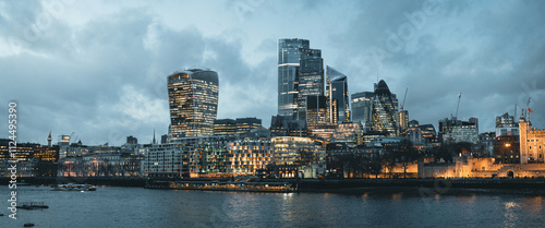 Canvas Print London skyline illuminating at dusk with tower of london and river thames