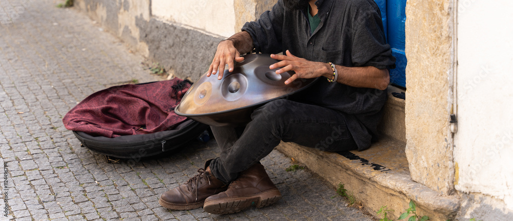 Man playing a handpan on the street. Street music. Man playing a handpan on the street. Street music.