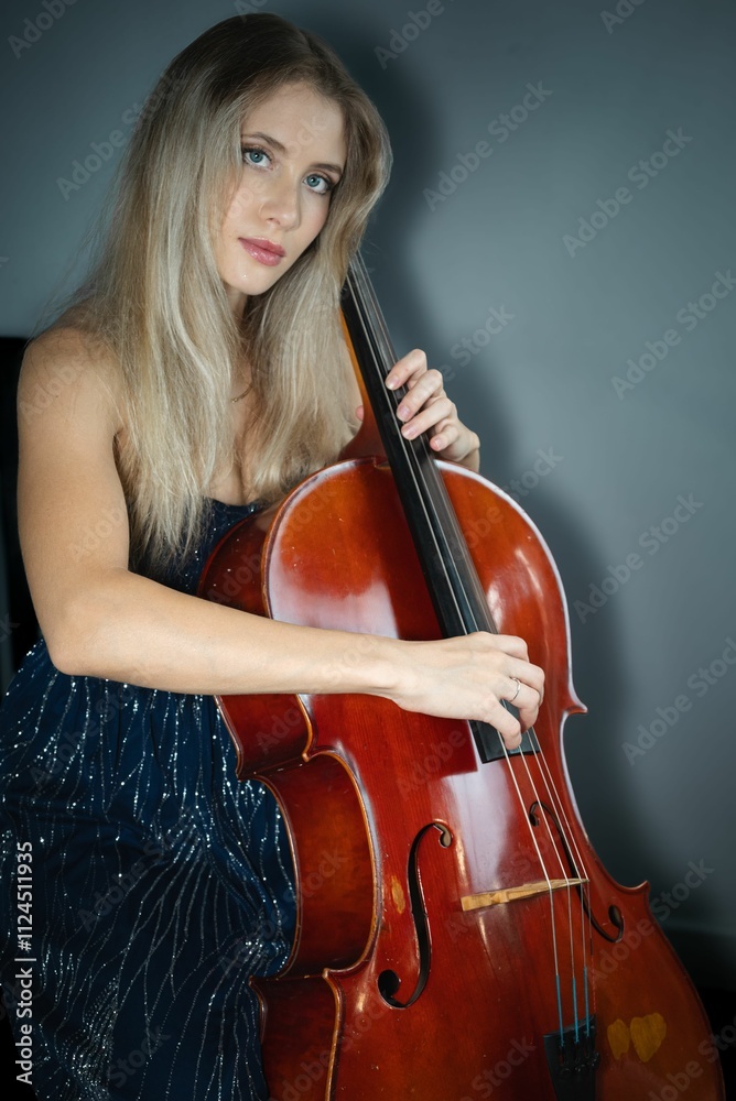 Young woman playing cello in elegant attire Young woman playing cello in elegant attire