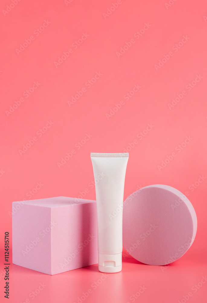 Plastic white tube for cream or lotion. Skin care or sunscreen cosmetic with stylish props on pink background. Plastic white tube for cream or lotion. Skin care or sunscreen cosmetic with stylish props on pink background.
