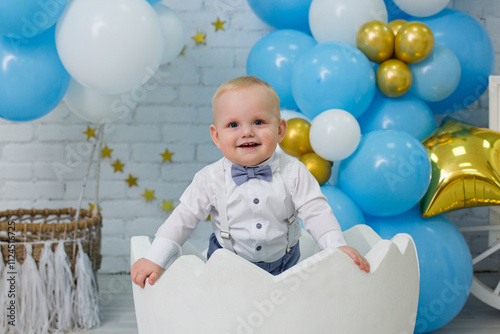 Adorable One-Year-Old Boy Celebrating First Birthday in Blue Decor