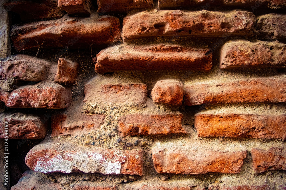 Old red brick wall with weathered texture and visible mortar, perfect for backgrounds or architectural studies Old red brick wall with weathered texture and visible mortar, perfect for backgrounds or architectural studies