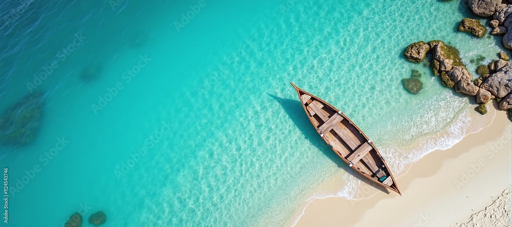 Serene aerial view of a tranquil beach, featuring a boat resting by the crystal-clear blue waters