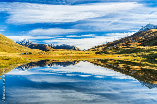 Scenic landscape of the Alps reflecting in a calm lake in the Grajischen Alps, France