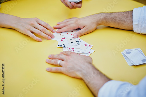Couple playing cards at table