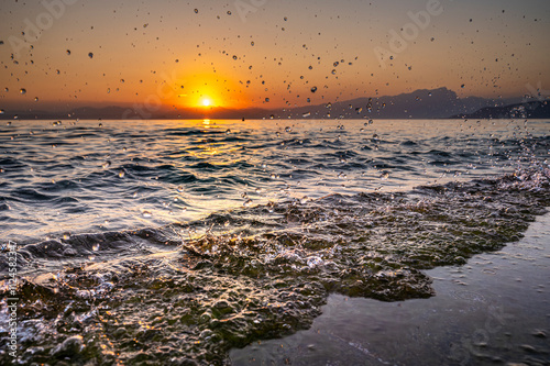 Water droplets in evening light at Lake Garda, Lazise, Veneto, Italy photo