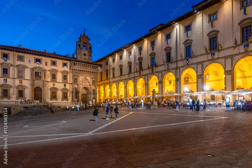 Piazza Grande with church of Santa Maria Della Pieve and palace Lay Fraternity at dusk under sky in Arezzo, Tuscany, Italy Piazza Grande with church of Santa Maria Della Pieve and palace Lay Fraternity at dusk under sky in Arezzo, Tuscany, Italy