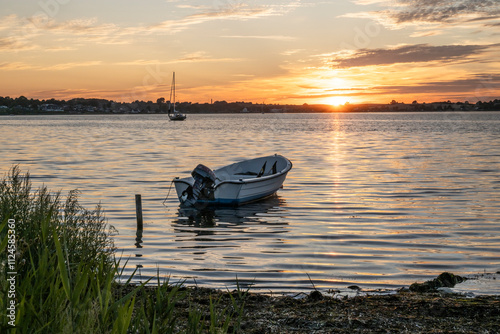 Boat on lake at sunset in Gammelmark Denmark photo