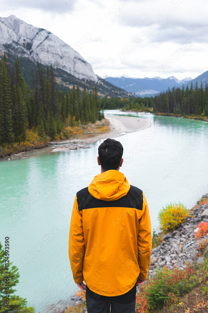 Male explorer looking at river view in national park Male explorer looking at river view in national park
