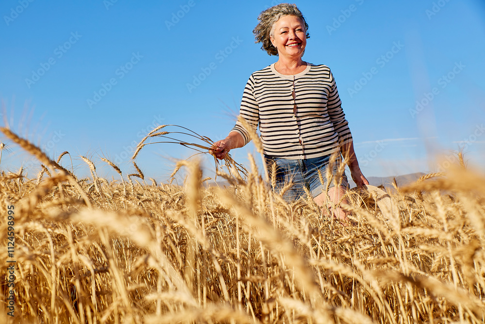 Happy woman walking amidst wheat stems on sunny day Happy woman walking amidst wheat stems on sunny day