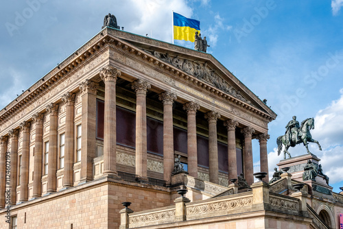 Neoclassical Old National Gallery on Museum Island in Berlin with equestrian statue and flag. photo