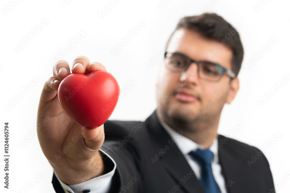 Selective focus close-up of red heart held by male entrepreneur Selective focus close-up of red heart held by male entrepreneur
